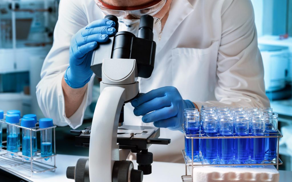 Person with microscope in laboratory